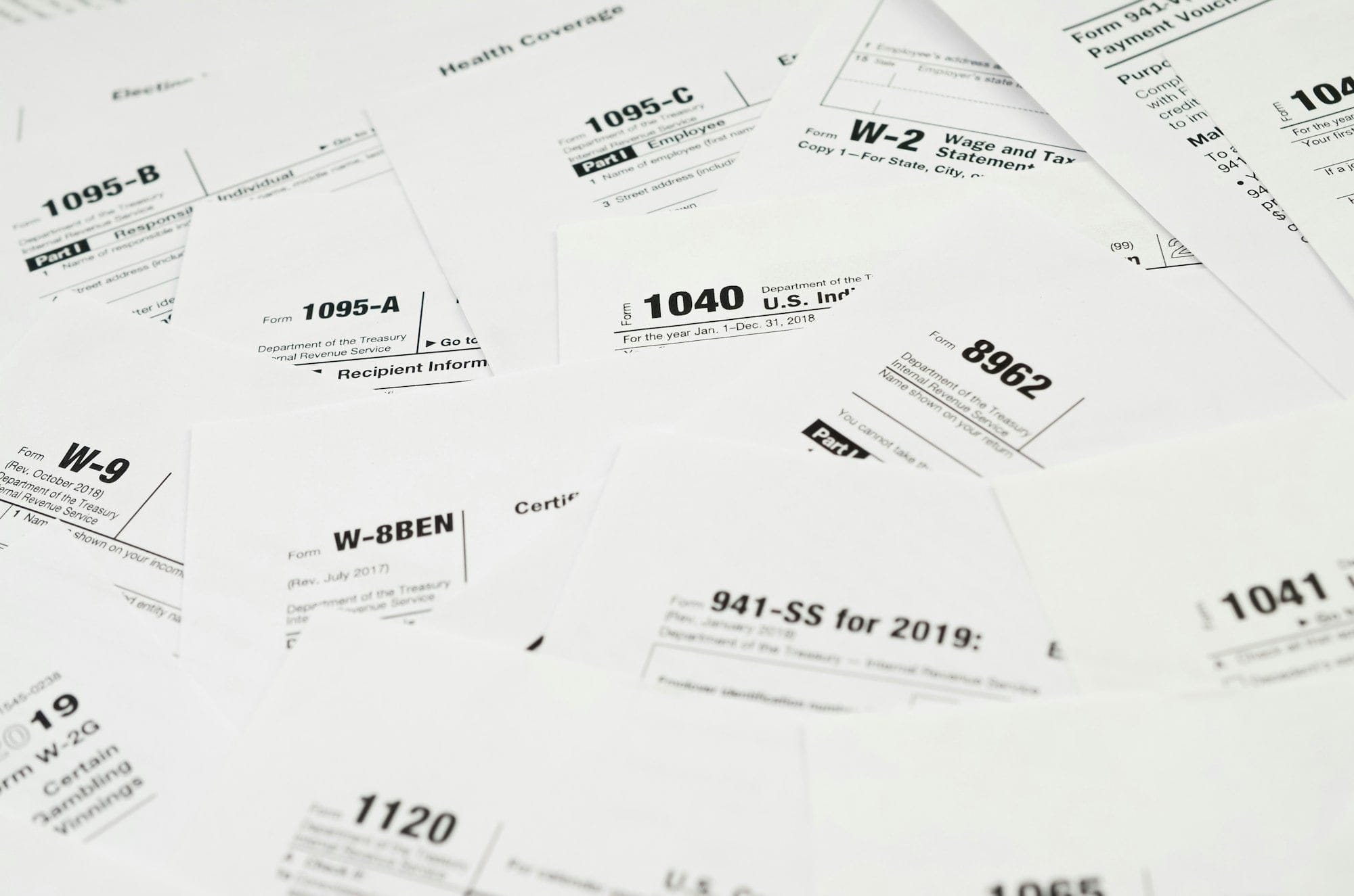 Many tax form blanks lies on table close up